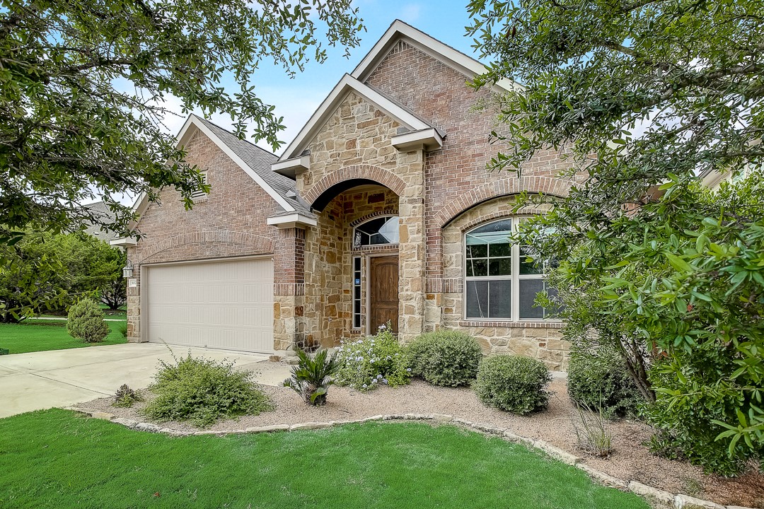 a front view of a house with a garden