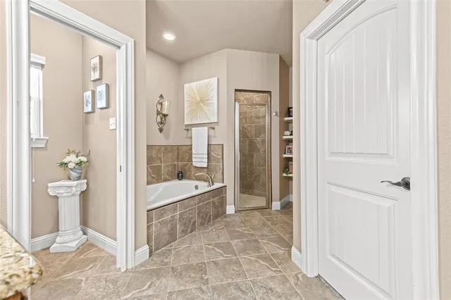 a bathroom with a tub shower and sink