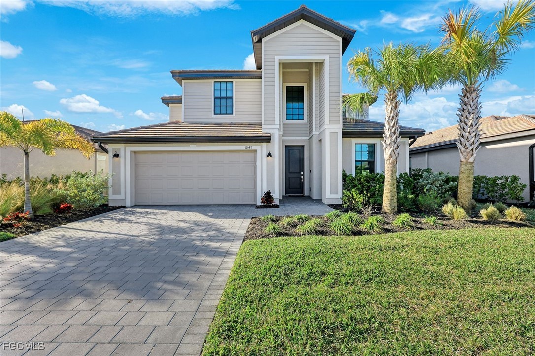 a front view of a house with a yard and garage
