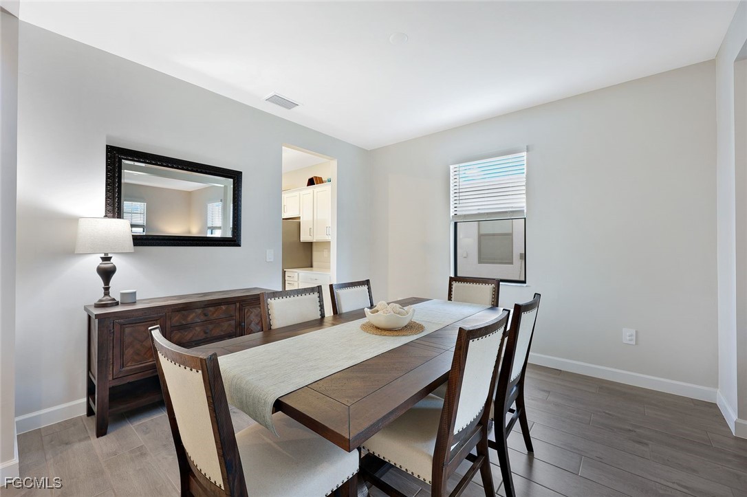 11087 Canopy Loop Fort Myers, FL 33913 - Photo 12 of 48 a dining room with furniture and wooden floor