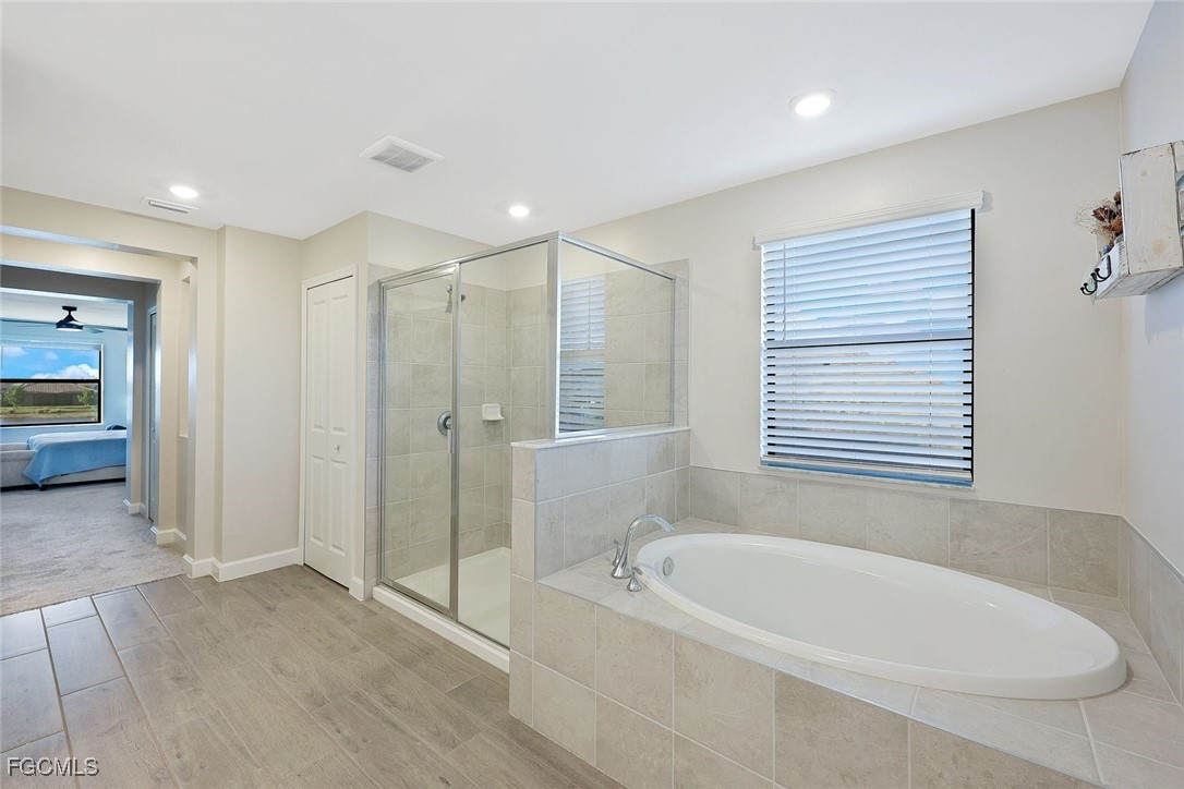 11087 Canopy Loop Fort Myers, FL 33913 - Photo 16 of 48 a bathroom with a bathtub and a shower
