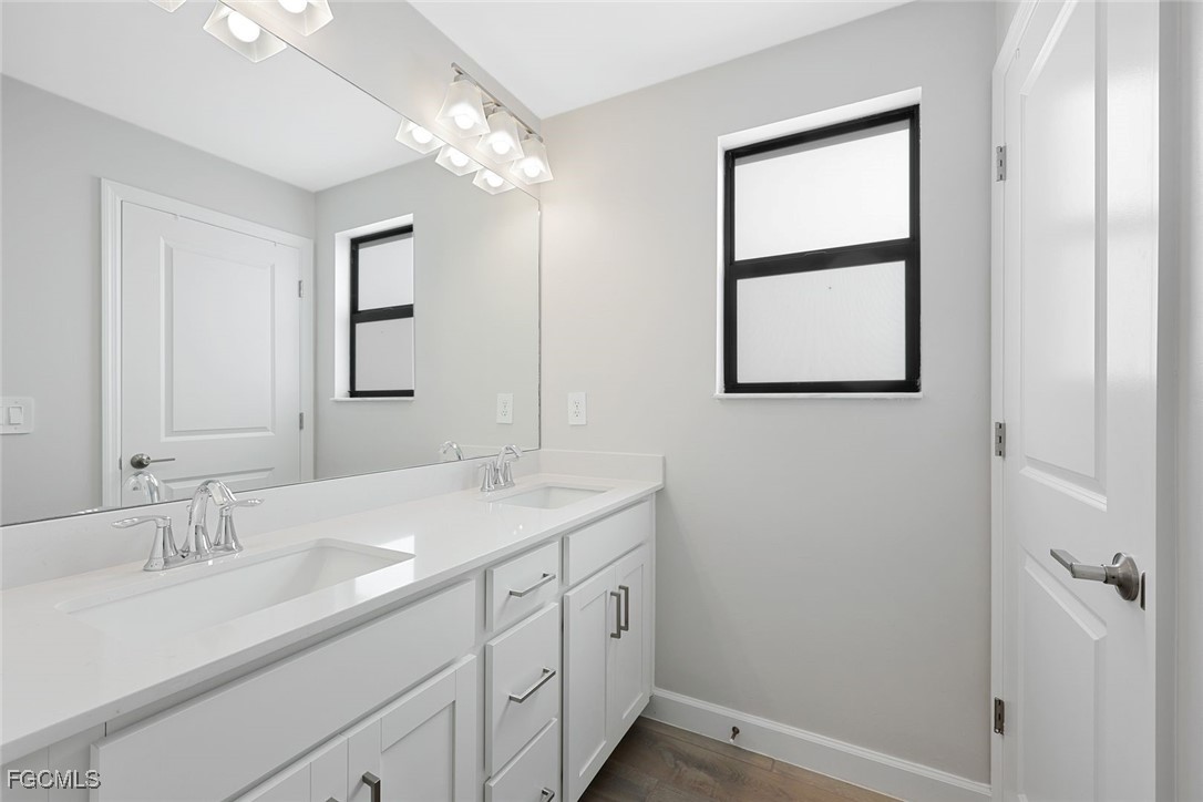 11087 Canopy Loop Fort Myers, FL 33913 - Photo 18 of 48 a bathroom with a double vanity sink and a mirror
