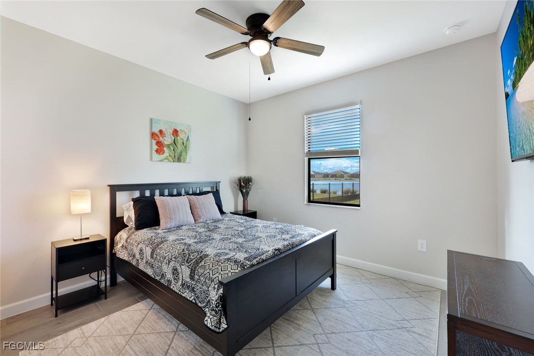 11087 Canopy Loop Fort Myers, FL 33913 - Photo 21 of 48 a bedroom with a bed and a chandelier