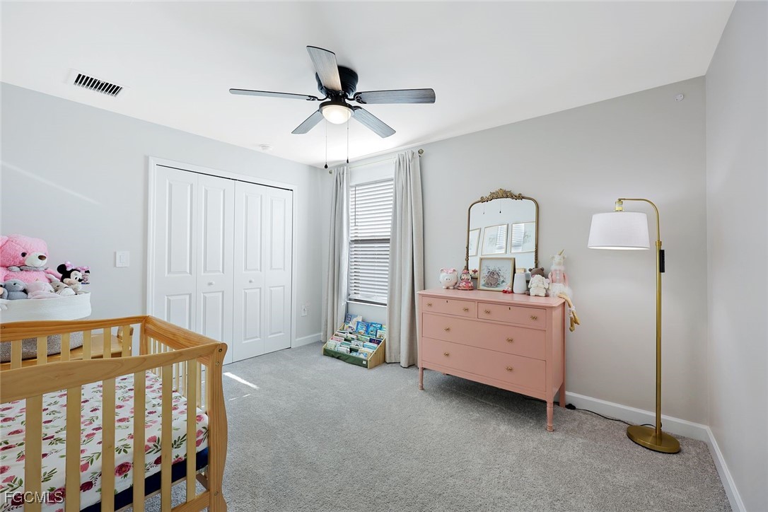 11087 Canopy Loop Fort Myers, FL 33913 - Photo 22 of 48 a bedroom with a bed and a chandelier