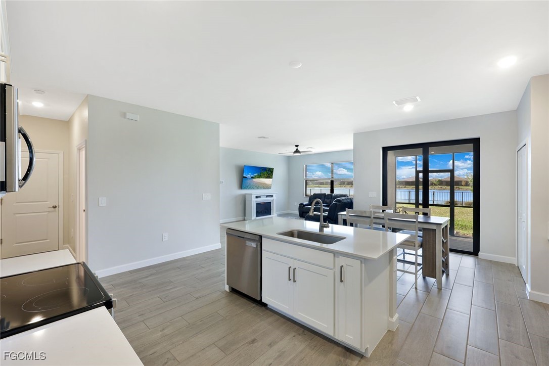 11087 Canopy Loop Fort Myers, FL 33913 - Photo 8 of 48 a kitchen with a sink stove and cabinets