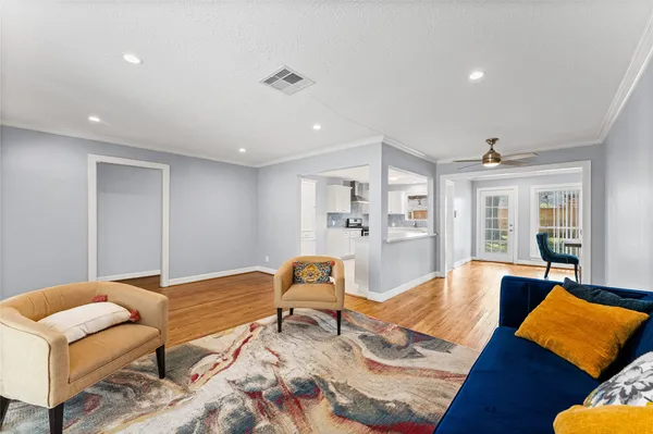 a living room with furniture rug and wooden floor
