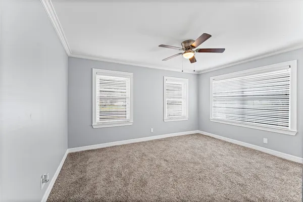 a view of a room with a window and a ceiling fan