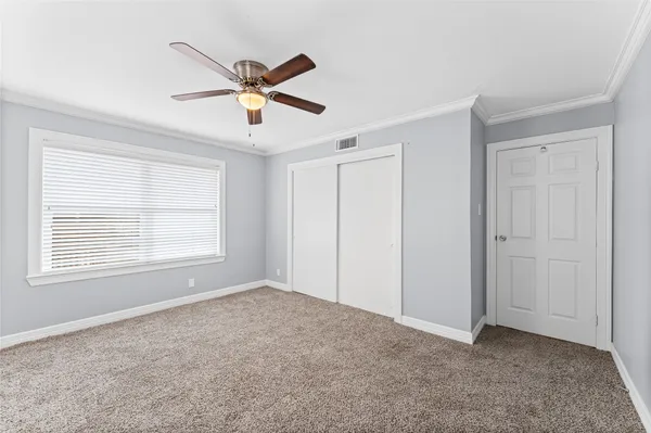a view of a livingroom with a ceiling fan & window