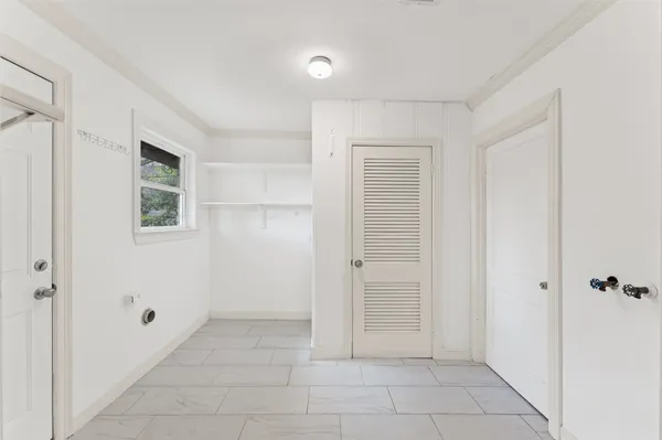 a picture of a cabinet with a white wall and white cabinet