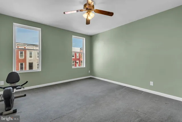 a view of room with window and ceiling fan