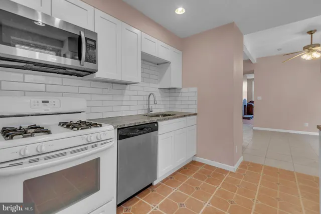 a kitchen with a stove top oven and cabinets