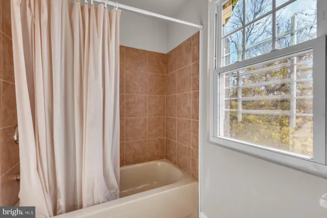 a bath tub sitting next to a window