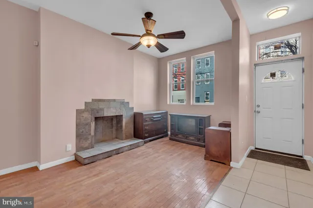 a living room with furniture and a fireplace