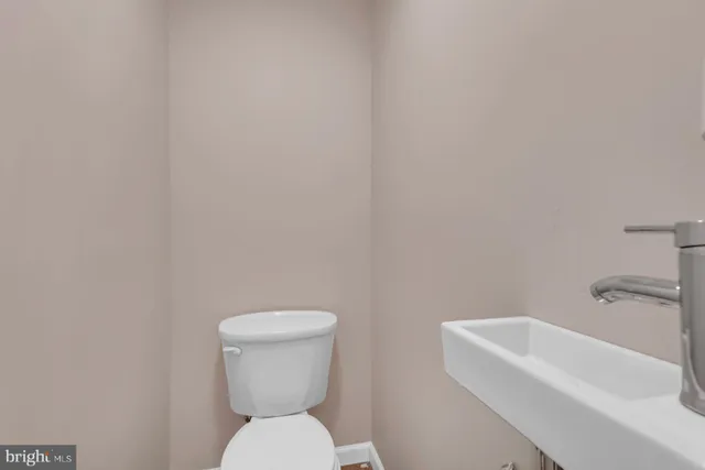 a white toilet sitting next to a white sink