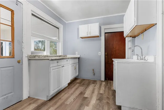 a room with a sink a washer and dryer