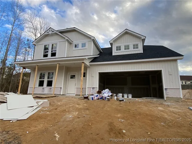 a view of a house with a yard and garage