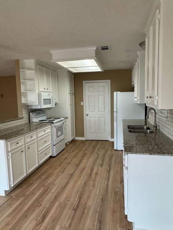 1809 Richmond Avenue Bryan, TX 77802 - Photo 4 of 12 a kitchen with granite countertop a sink stainless steel appliances and cabinets