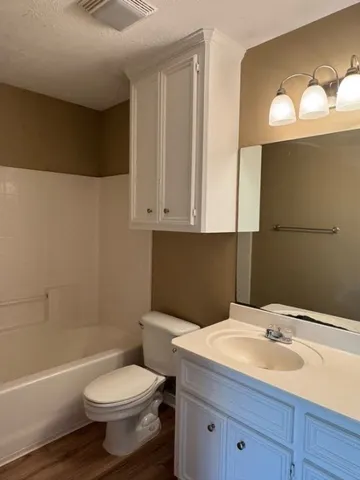 a bathroom with a sink a toilet and bathtub