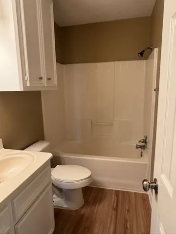 a white toilet sitting next to a bathroom sink