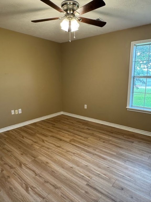 1809 Richmond Avenue Bryan, TX 77802 - Photo 10 of 12 an empty room with a window and wooden floor