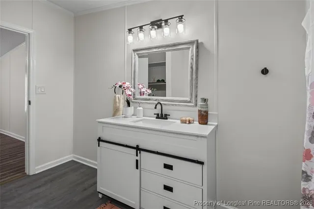 a bathroom with a sink a mirror and a bathtub