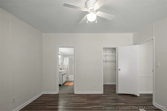 a view of a room with a window and wooden floor