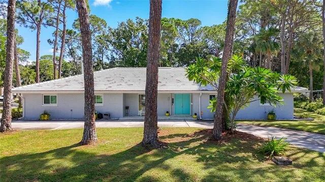 a view of a house with swimming pool and a yard