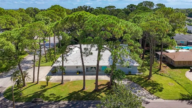 an aerial view of a houses with a yard