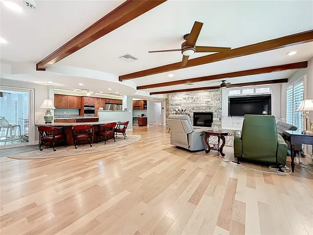 a large kitchen with stainless steel appliances wooden cabinets and a granite counter tops