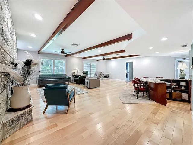 a spacious bedroom with a bed and chair