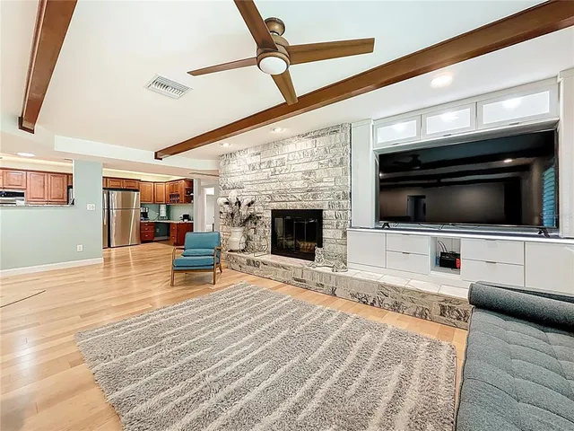 a spacious bedroom with a bed and a flat screen tv