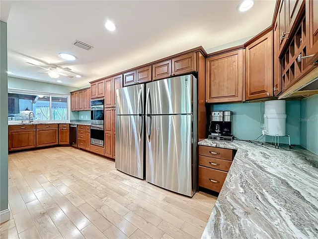 a spacious bathroom with a double vanity sink a mirror and a shower
