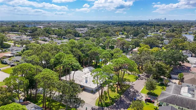 an aerial view of residential building with green space