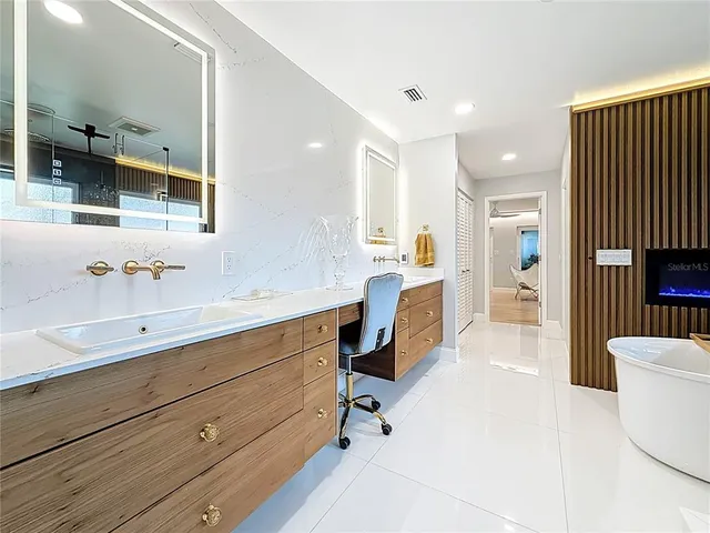 a view of a house with backyard and a tree