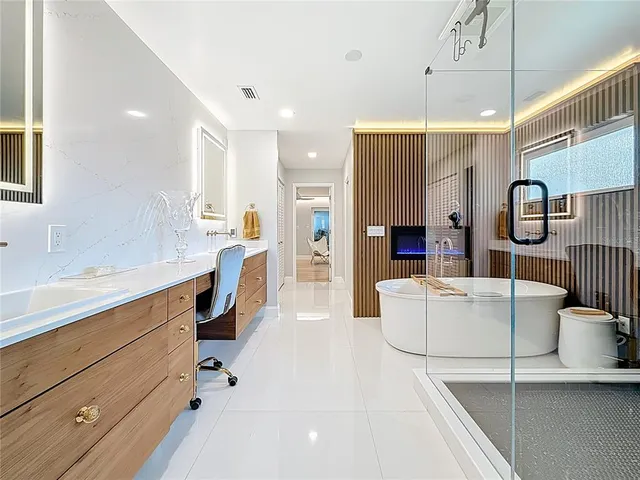a view of a patio with table and chairs with wooden floor and fence