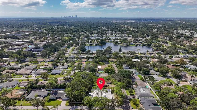 a front view of a house with a garden and potted plants