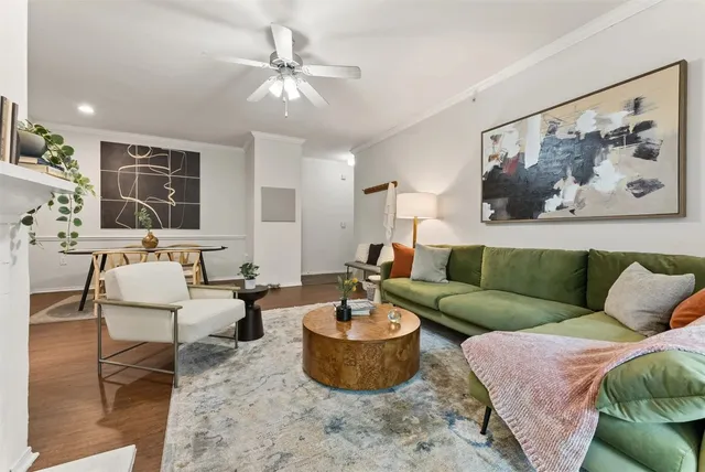a living room with dining table and wooden floor