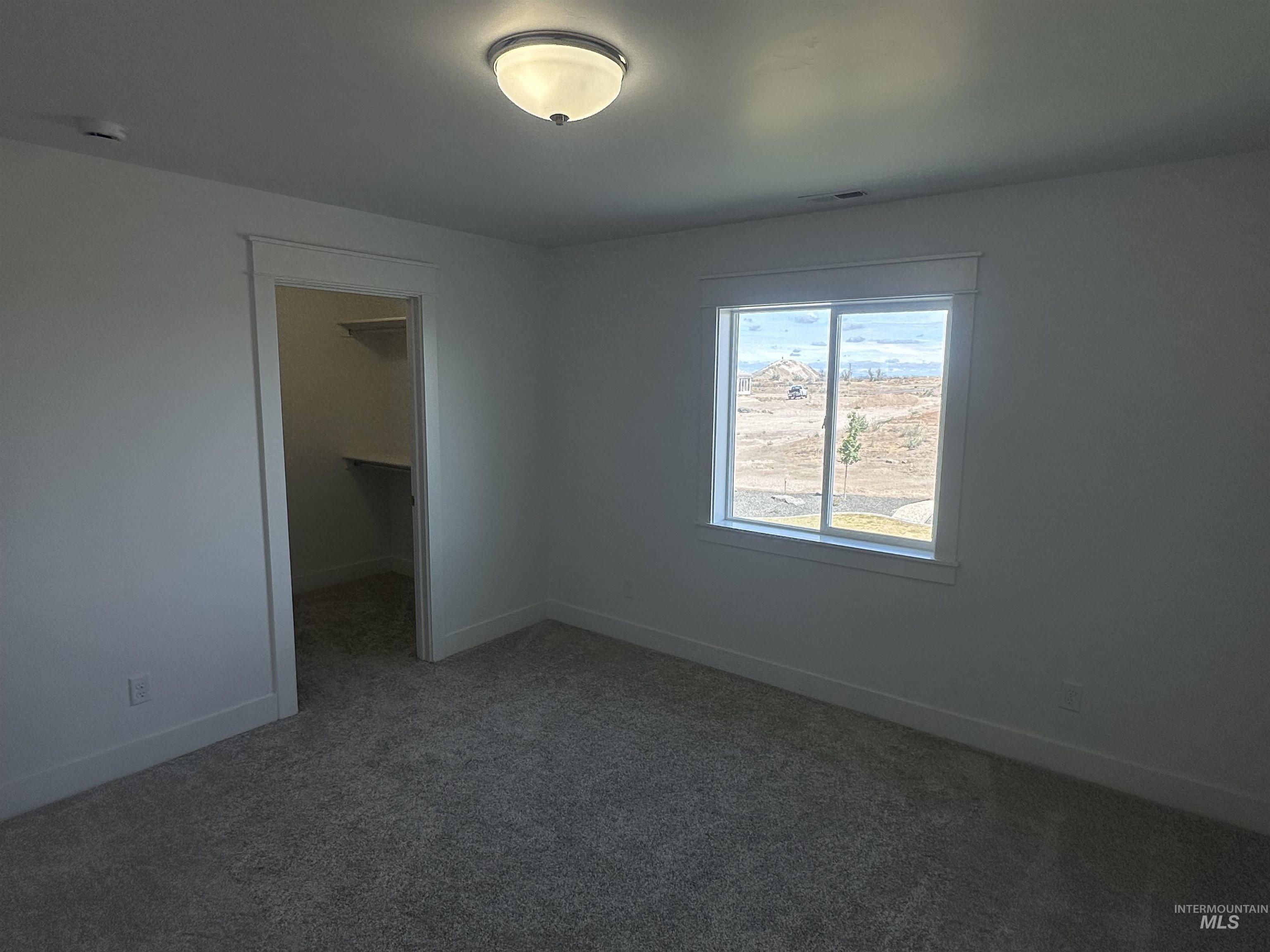 3035 Lake View Twin Falls, ID 83301 - Photo 27 of 41 Spacious walk-in closet featuring built-in shelving, hanging rods, and carpet flooring