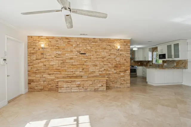 a kitchen with stainless steel appliances granite countertop a refrigerator stove and sink