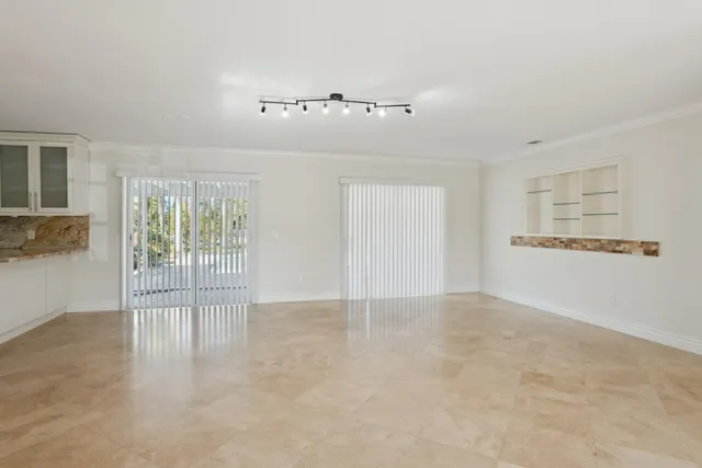 a kitchen with granite countertop white cabinets stainless steel appliances and a sink