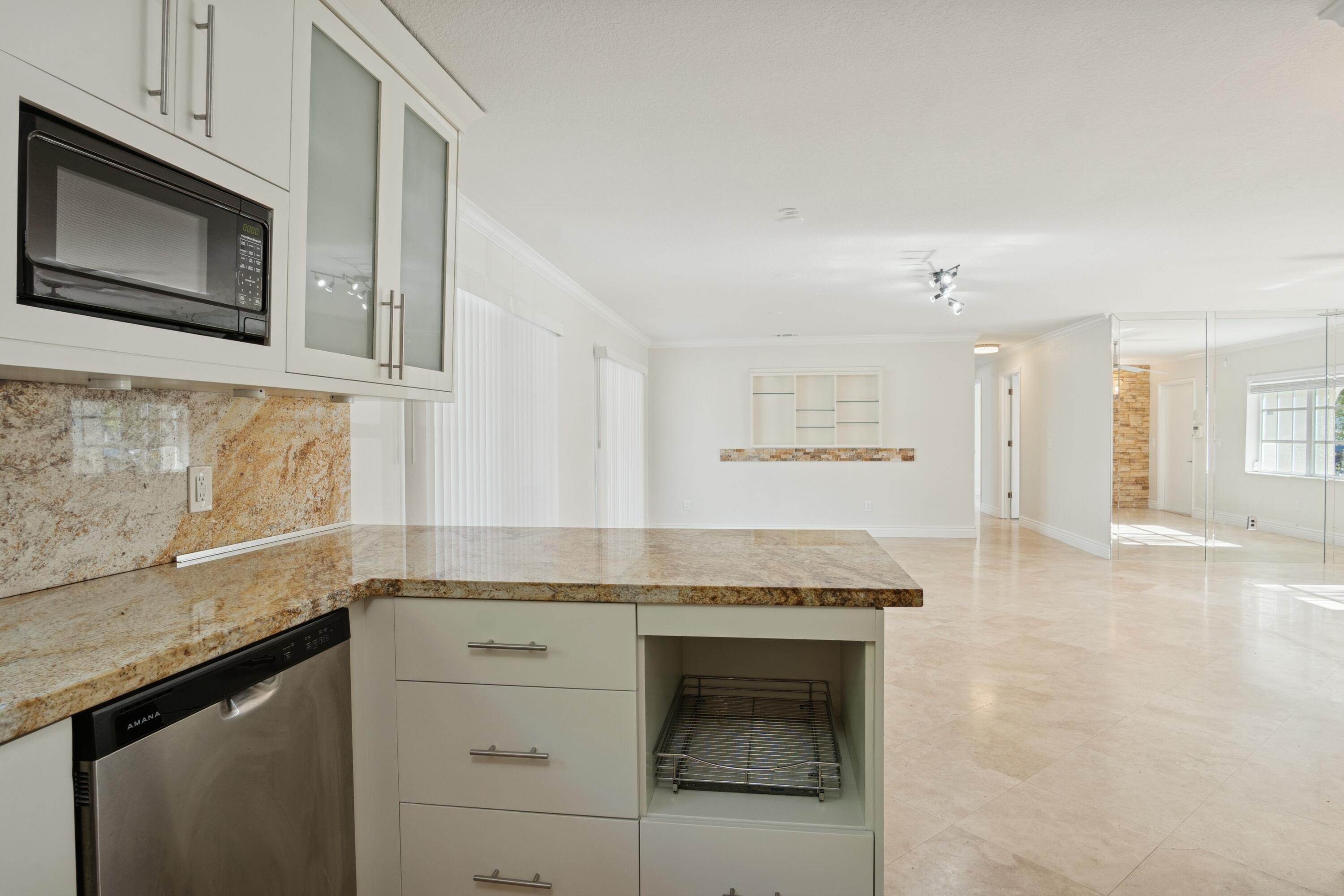4971 Ataman Street Boca Raton, FL 33428 - Photo 17 of 35 a kitchen with granite countertop cabinets stainless steel appliances and a counter space