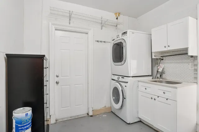 a view of an empty room with cabinet and a window