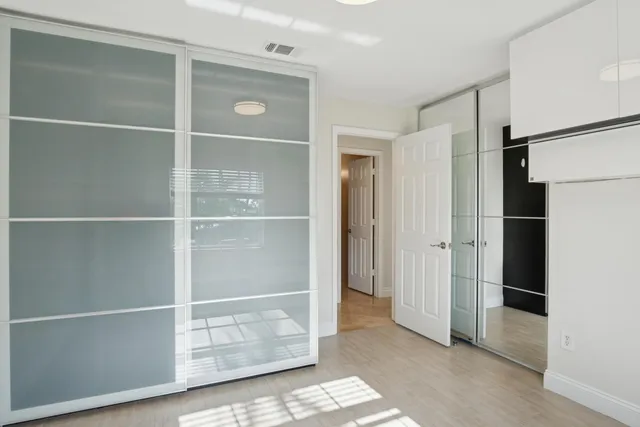 a bathroom with a shower sink vanity and toilet