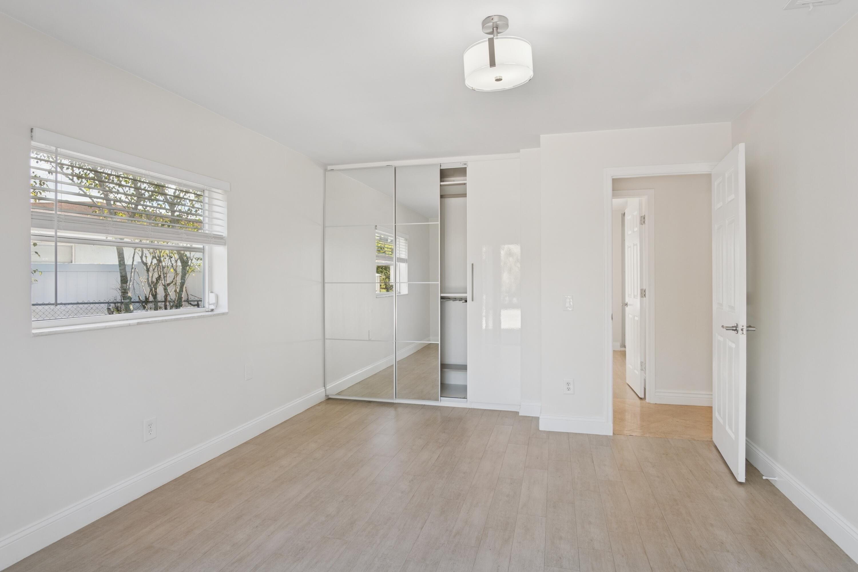 4971 Ataman Street Boca Raton, FL 33428 - Photo 28 of 35 a view of a big room with windows and chandelier fan