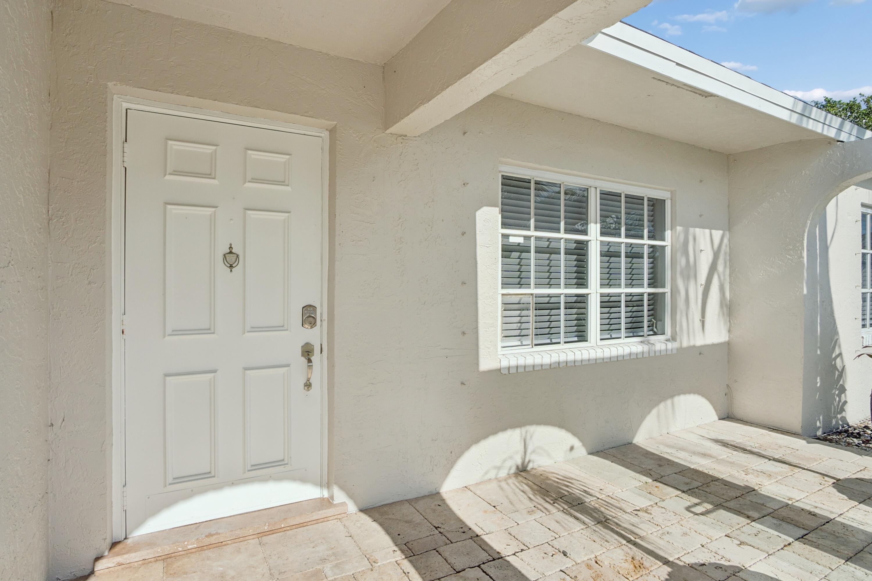 4971 Ataman Street Boca Raton, FL 33428 - Photo 33 of 35 a bedroom with a bed and a window