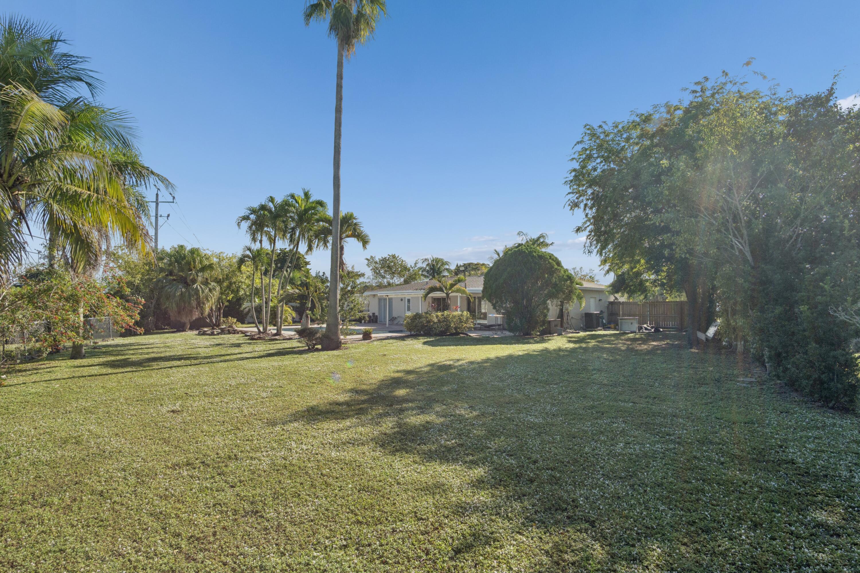 4971 Ataman Street Boca Raton, FL 33428 - Photo 6 of 35 a backyard of a house with lots of green space
