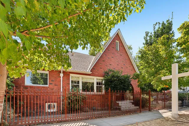 a view of house with a tree and a yard