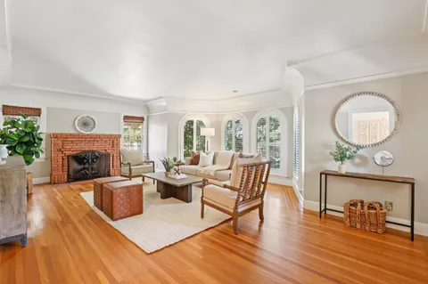 a view of a dining room with furniture a chandelier and wooden floor