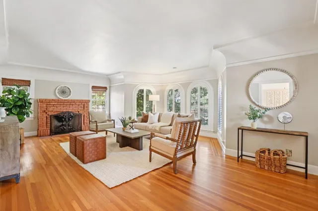 a view of a dining room with furniture a chandelier and wooden floor