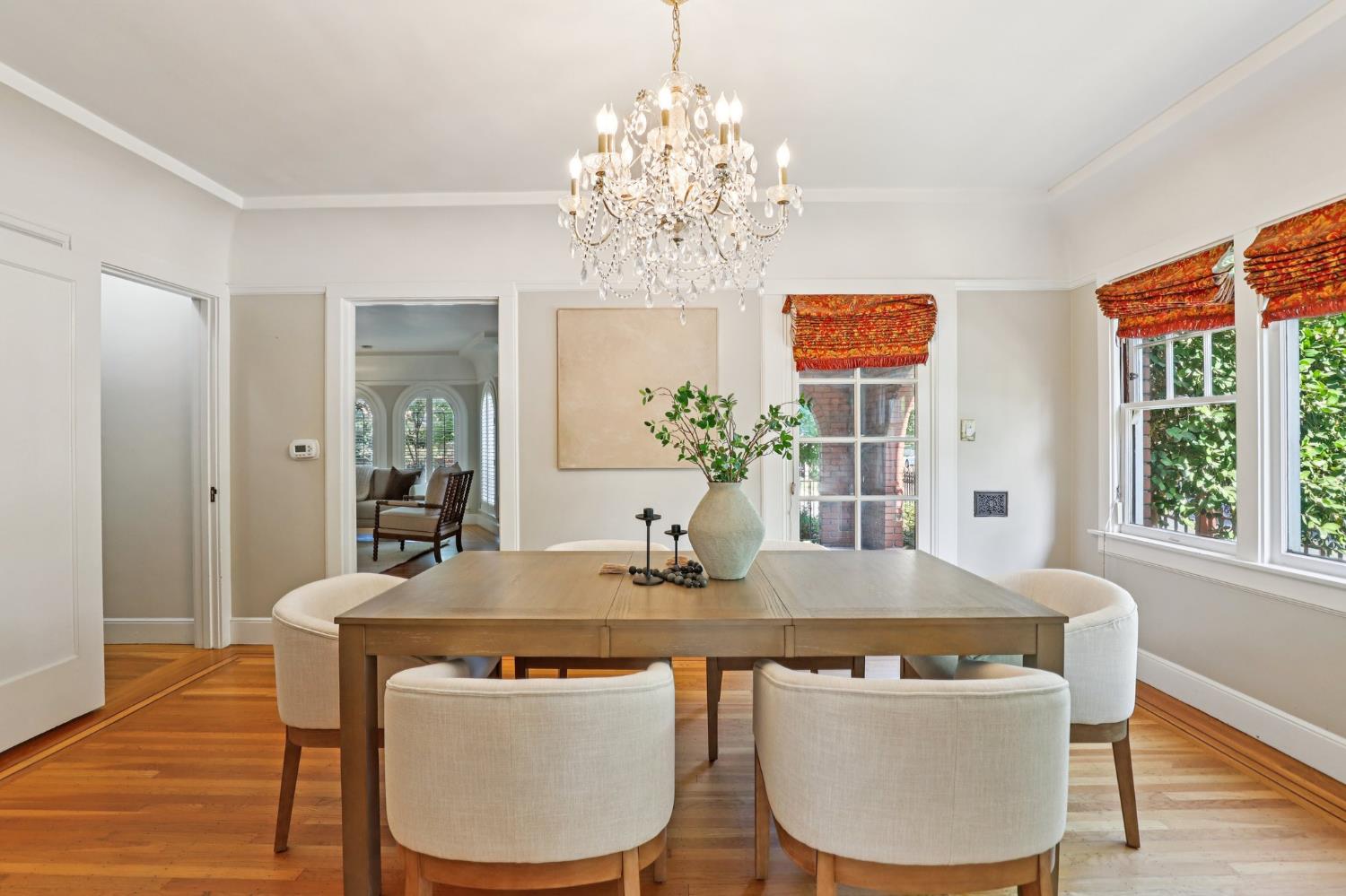 2200 2nd Avenue Sacramento, CA 95818 - Photo 20 of 69 a dining room with wooden floor a chandelier a wooden table and chairs